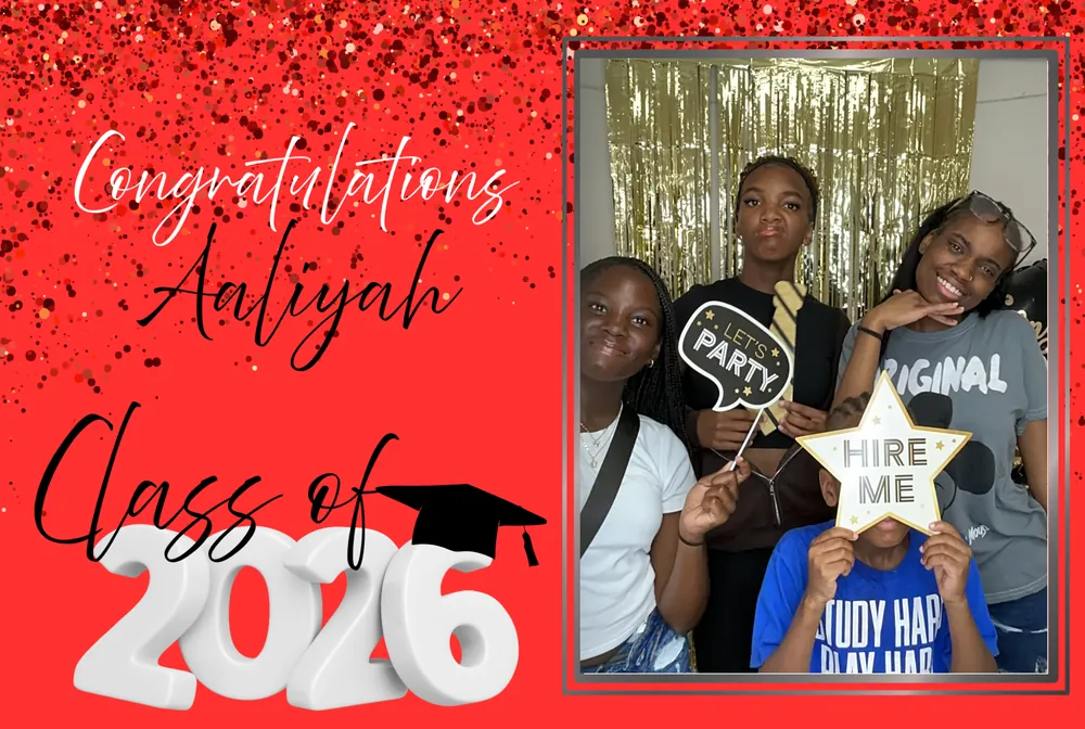 Graduation guests smiling together and holding party props in the photo booth